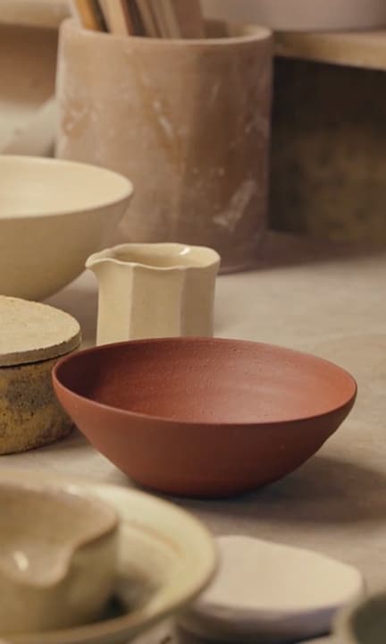 Handmade ceramics on a wooden shelf